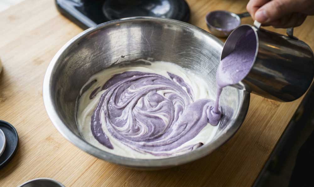 How to Make Ube Ice Cream Preparing ube ice cream by mixing the purple ube mixture with the ice cream base