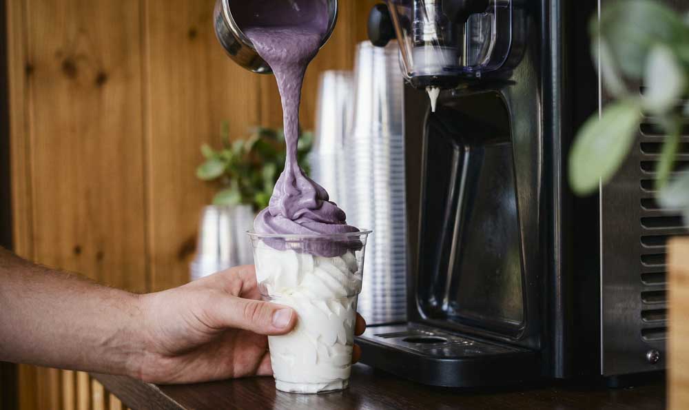Trendy Ube Desserts for Cafés Trendy ube dessert with purple and cream soft serve ice cream served in a bowl