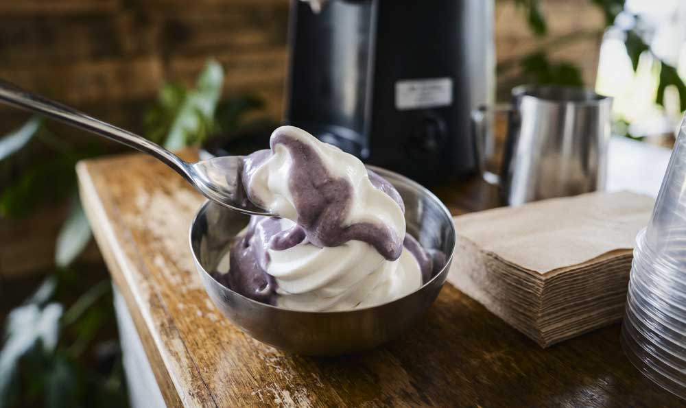 Trendy Ube Desserts Trendy ube dessert with purple and cream soft serve ice cream served in a bowl